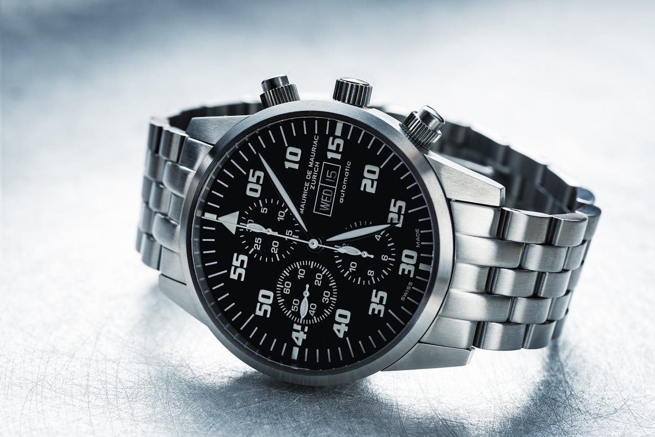 Close-up shot of a sleek stainless steel chronograph watch with black dial.